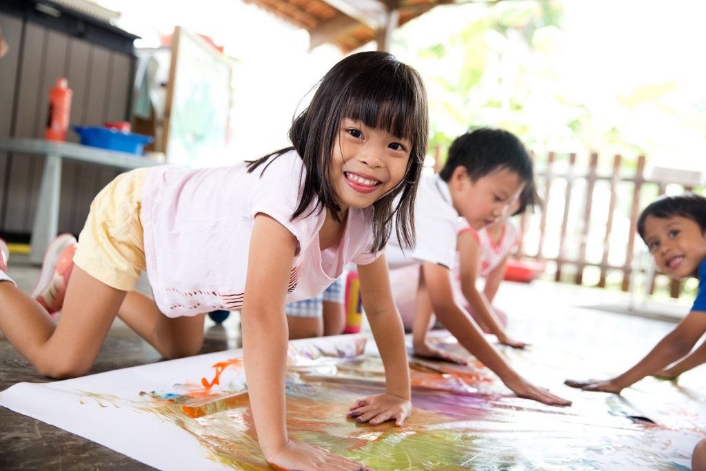 A group of preschool children painting