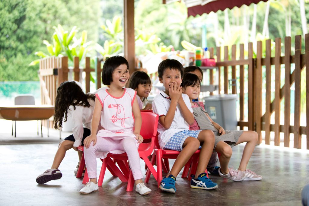 Preschoolers playing musical chairs