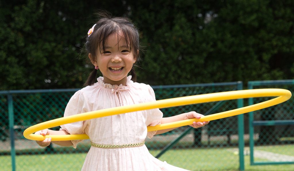 Cheerful Girl with a Hula Hoop