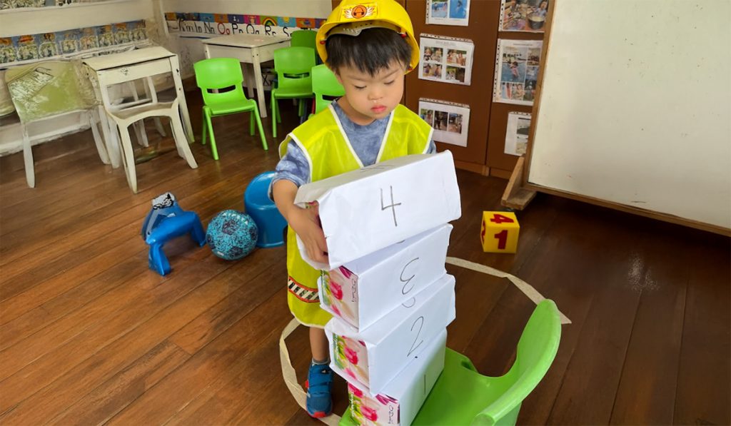 preschooler building a tower