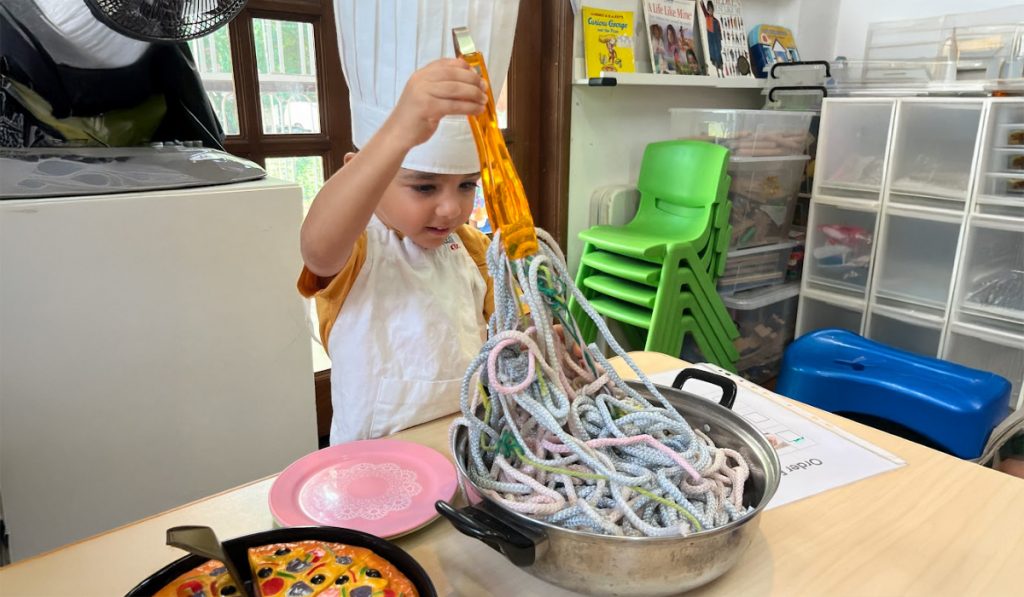 preschooler as a pretend chef
