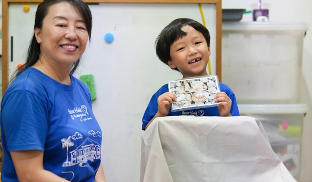  teacher and preschooler during a show and tell
