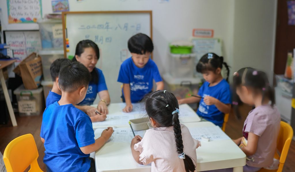 Kindergarten 2 children practising their writing