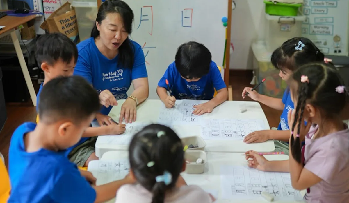 teacher working with a small group of preschoolers