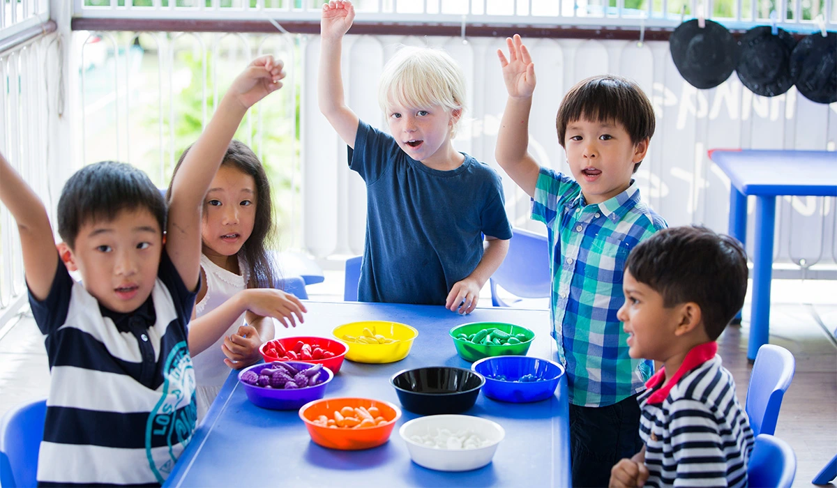 Preschoolers raising hands
